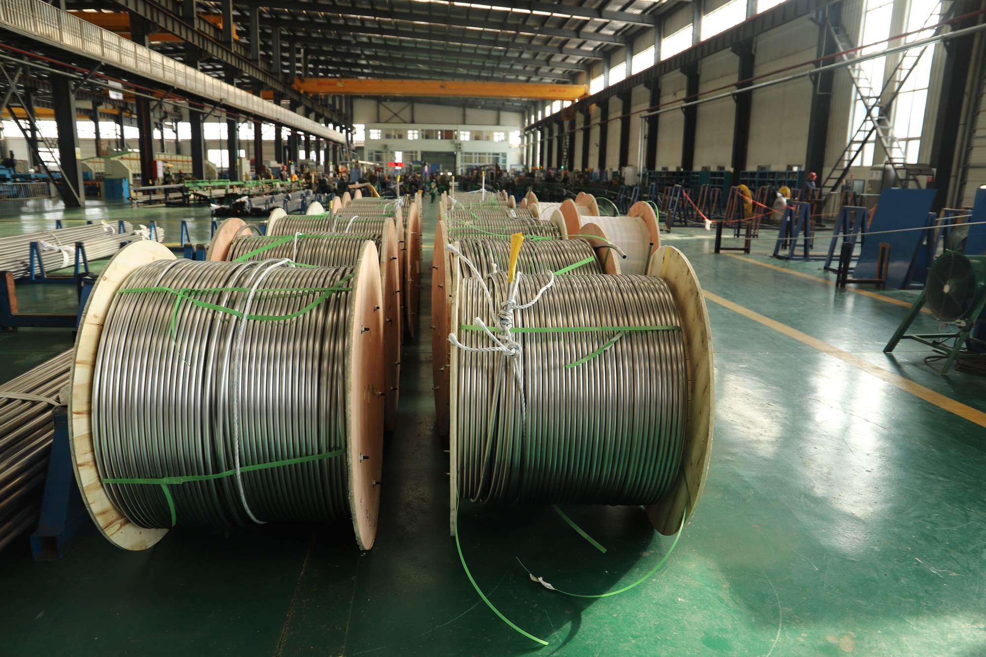 Cable and conductor manufacturing floor with production crew.